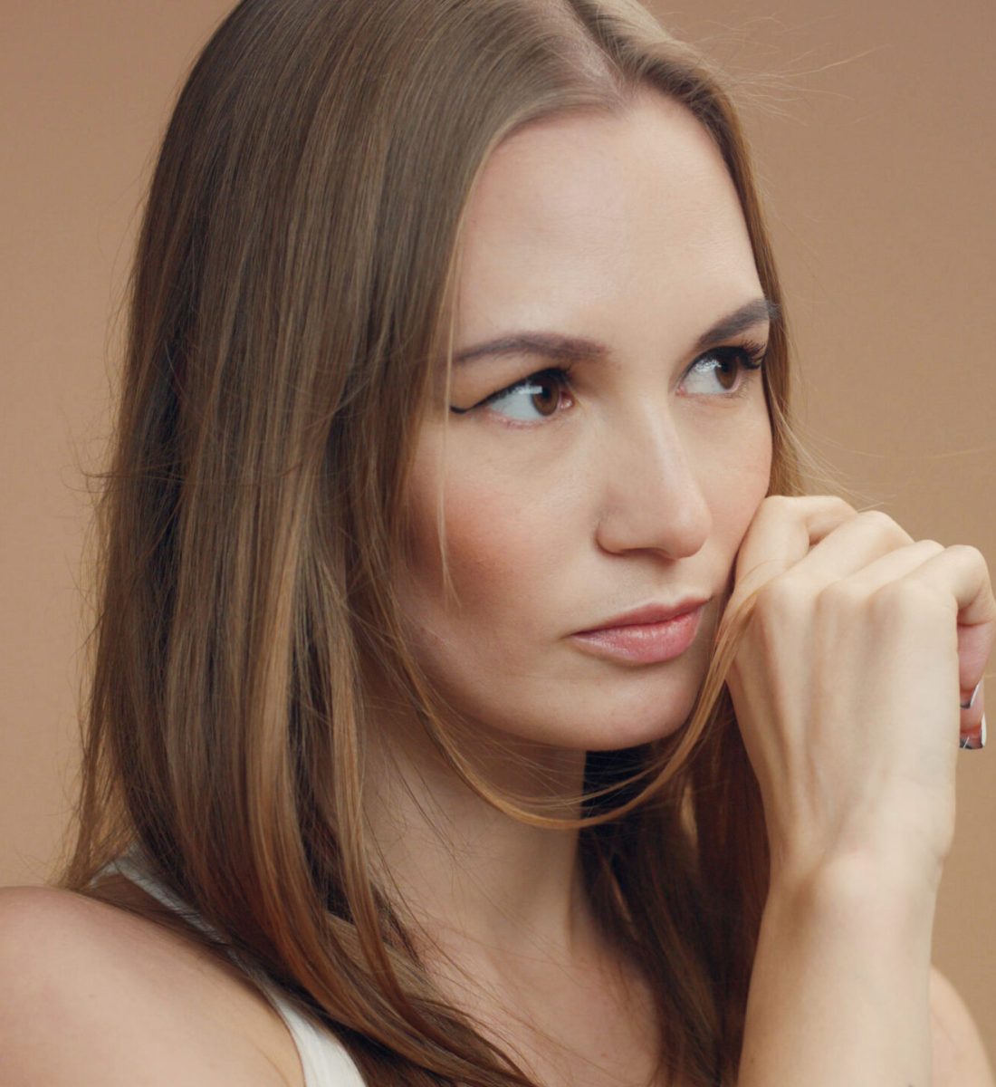 woman's portrait joying of wind moving her straight hair slowly